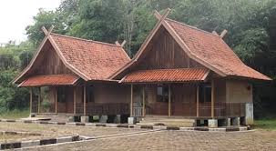 A traditional Sundanese house with a 'Badak Heuay' roof, showcasing its unique sloping structure that resembles a yawning rhino.
